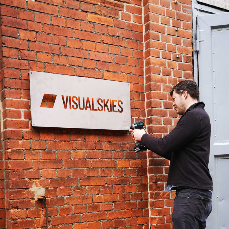 Berlin Visualskies Ltd Ross putting up visualskies sign